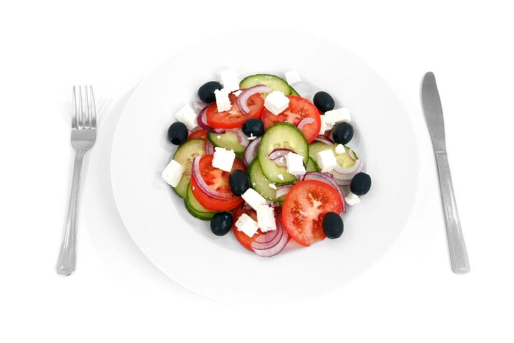 A plate of Greek salad with feta and Kalamata olives